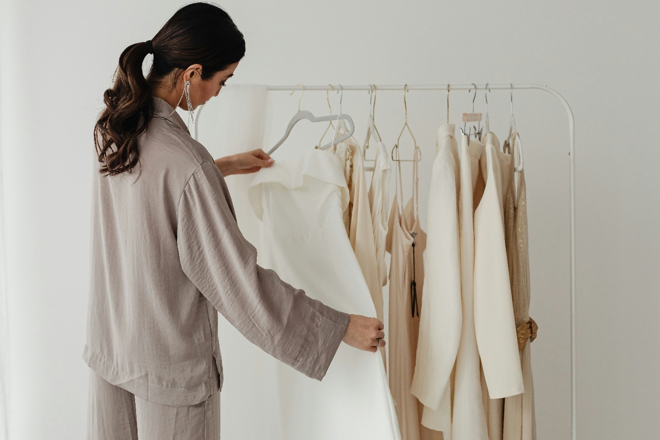 woman looking at rail of clothes